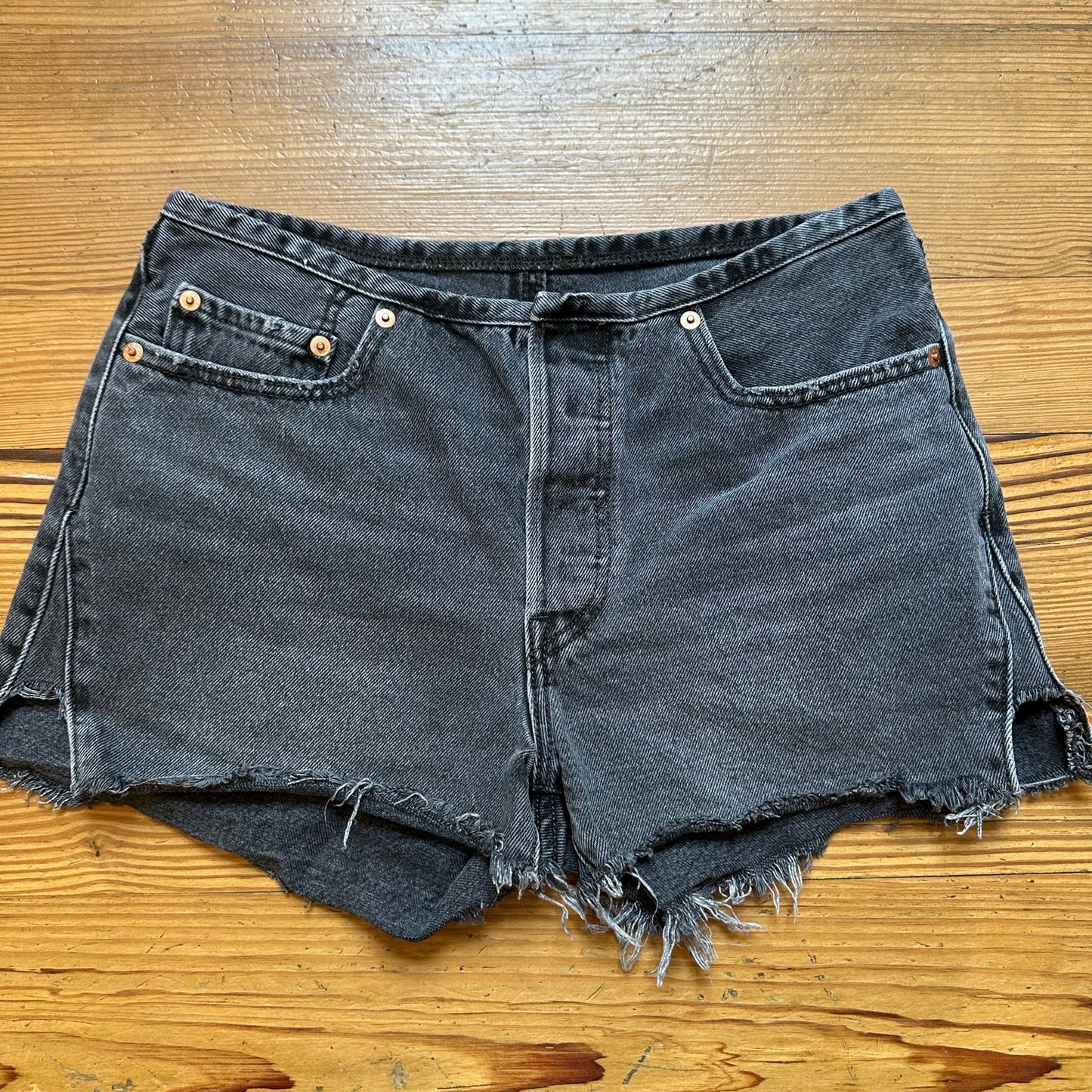 Levi's 501 distressed raw hem button fly black jean shorts SIZE 27