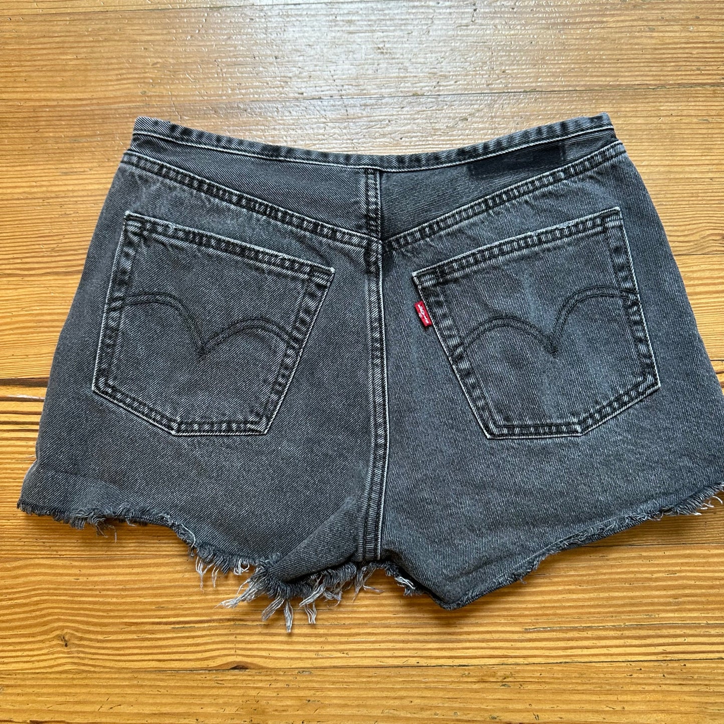 Levi's 501 distressed raw hem button fly black jean shorts SIZE 27