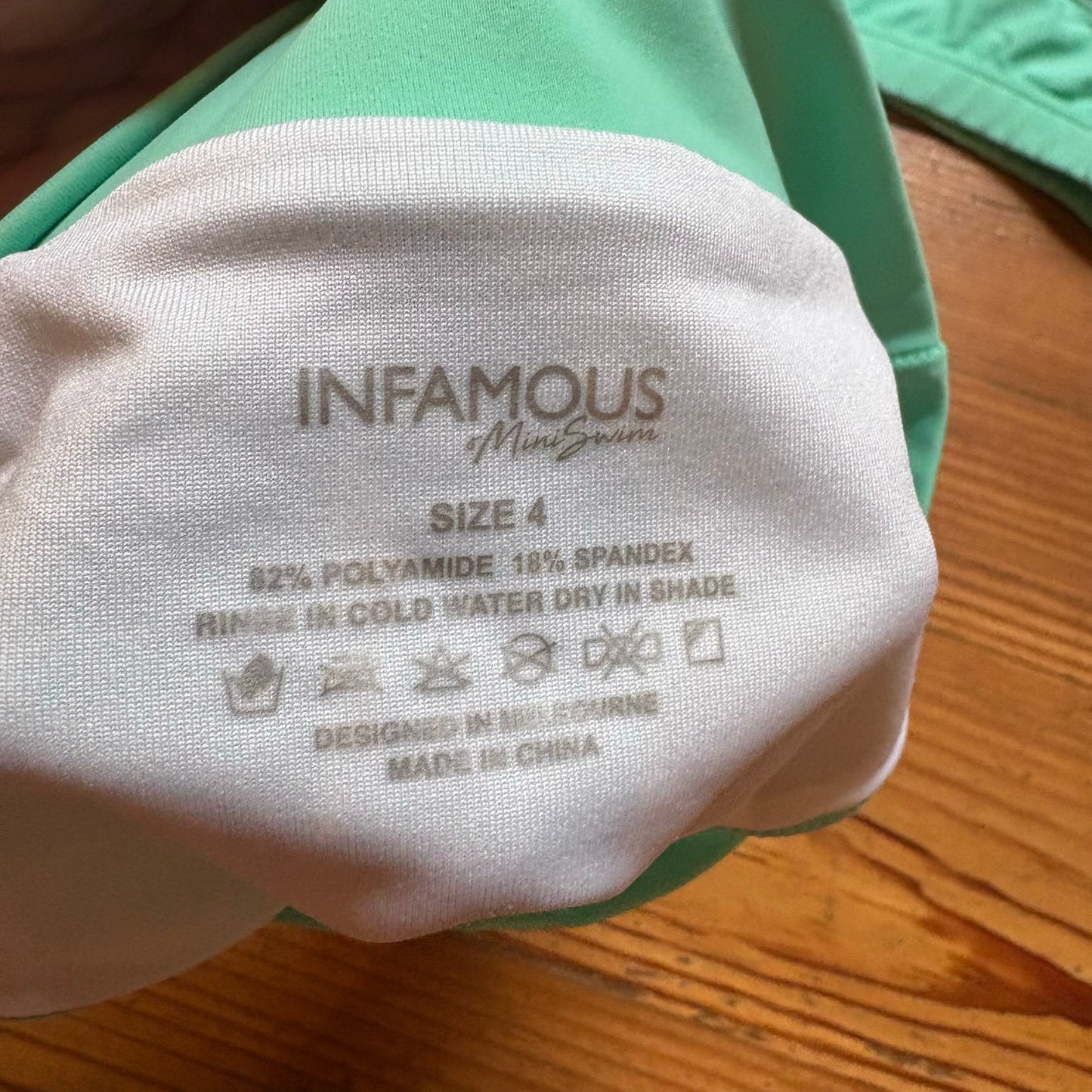Infamous pastel green racer back girls swimsuit SIZE 4